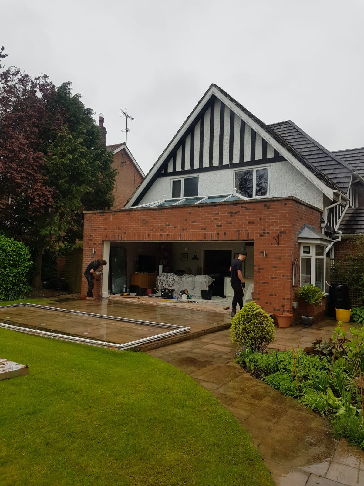 Anthracite windows and bifolds on a gable extension seen from the garden, installed by WGS Glazing