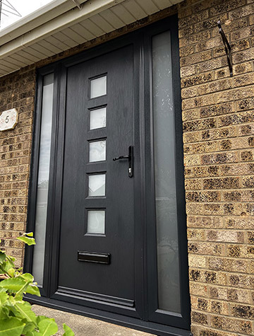 Dark Rockdoor entrance door with square glass lights and sidelights, supplied by WGS Glazing
