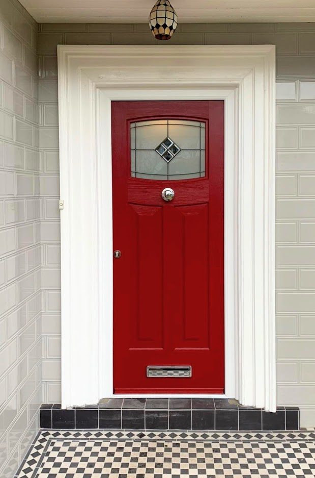 Red traditional Rockdoor with leaded feature glass in a tiled porch, supplied by WGS Glazing