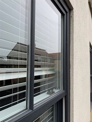 Anthracite PVCu sliding sash window detail, supplied by WGS Glazing